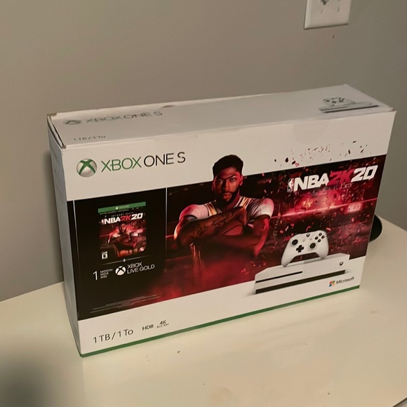 Xbox one S 1 T, with 2 controllers, 2 games, and a rechargeable battery.